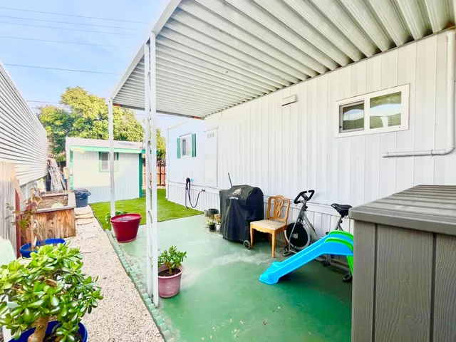 a view of a backyard with white fence