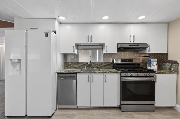 a view of an entryway with wooden floor