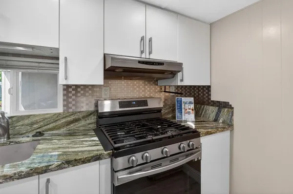 a view of a backyard with a small cabin and wooden fence