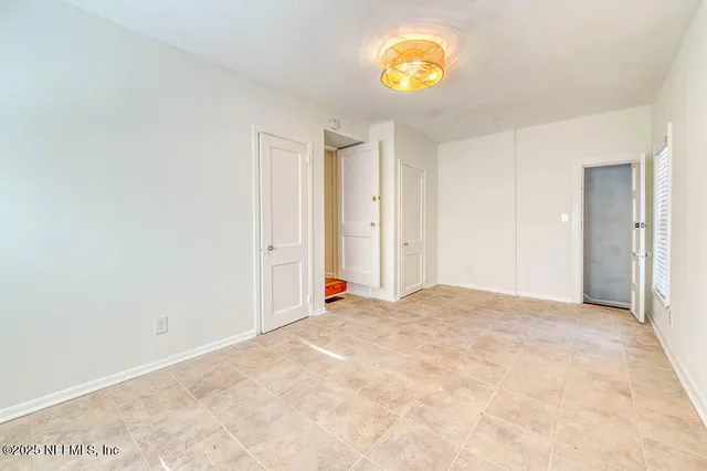 a view of an empty room and a window