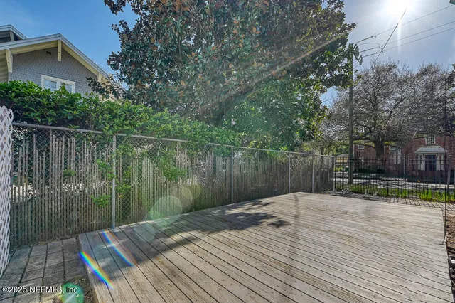 a wooden deck with sunset view