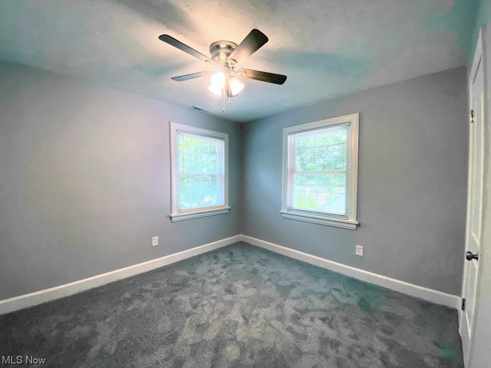 2140 Reyburn Road Cleveland, OH 44112 - Photo 10 of 18 Empty room with dark colored carpet and ceiling fan
