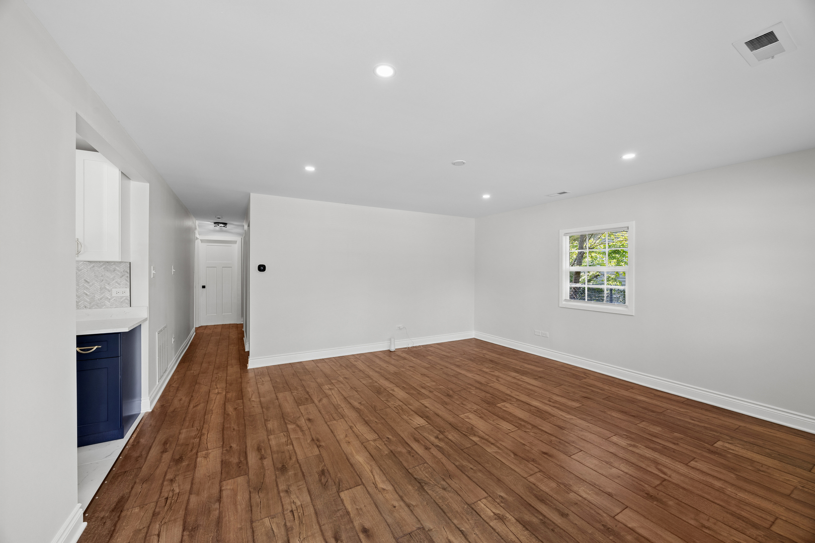 570 Andover Street Chicago Heights, IL 60411 - Photo 5 of 22 a view of an empty room with wooden floor and a window