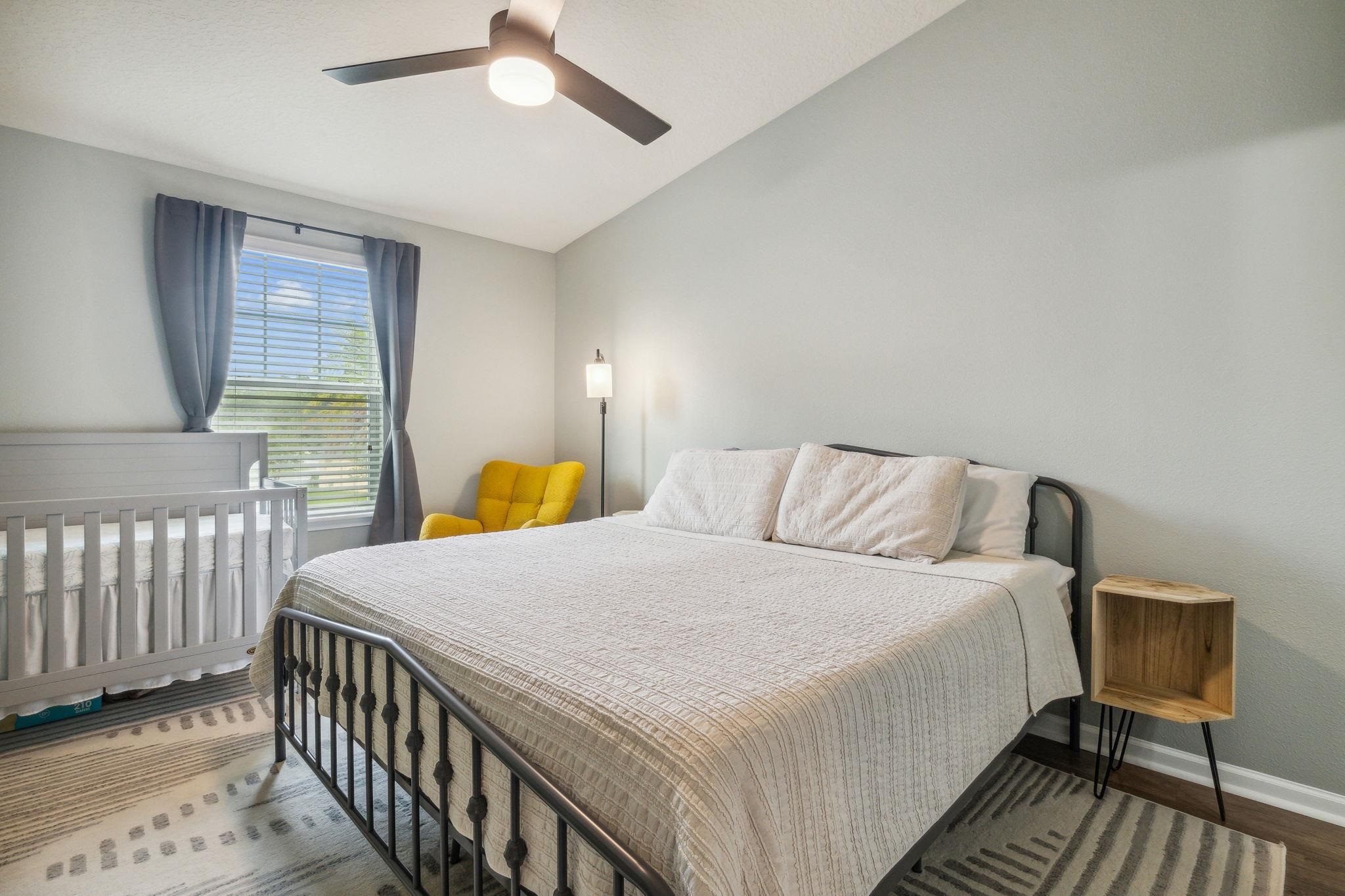 1217 Golden Lake Loop St. Augustine, FL 32084 - Photo 15 of 32 a bedroom with a bed and a chandelier