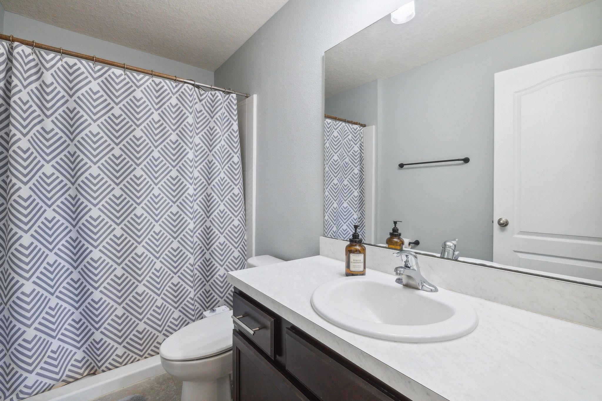 1217 Golden Lake Loop St. Augustine, FL 32084 - Photo 19 of 32 a bathroom with a sink toilet and mirror