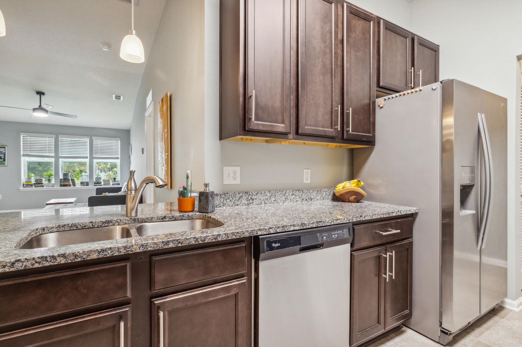 1217 Golden Lake Loop St. Augustine, FL 32084 - Photo 10 of 32 a kitchen with granite countertop a sink stainless steel appliances and cabinets
