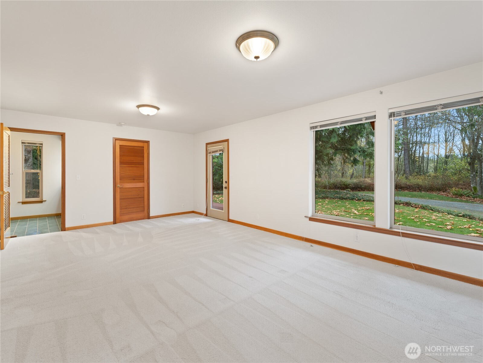 2204 41st Street Anacortes, WA 98221 - Photo 18 of 36 a view of an empty room with wooden floor and a window