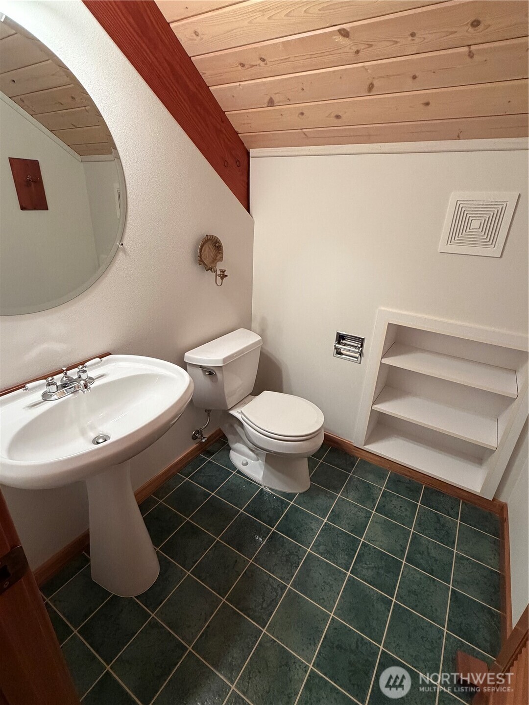 2204 41st Street Anacortes, WA 98221 - Photo 25 of 36 a bathroom with a toilet a sink and a mirror