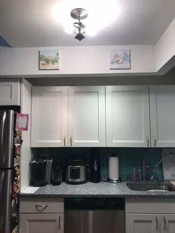 a kitchen with a sink and cabinets