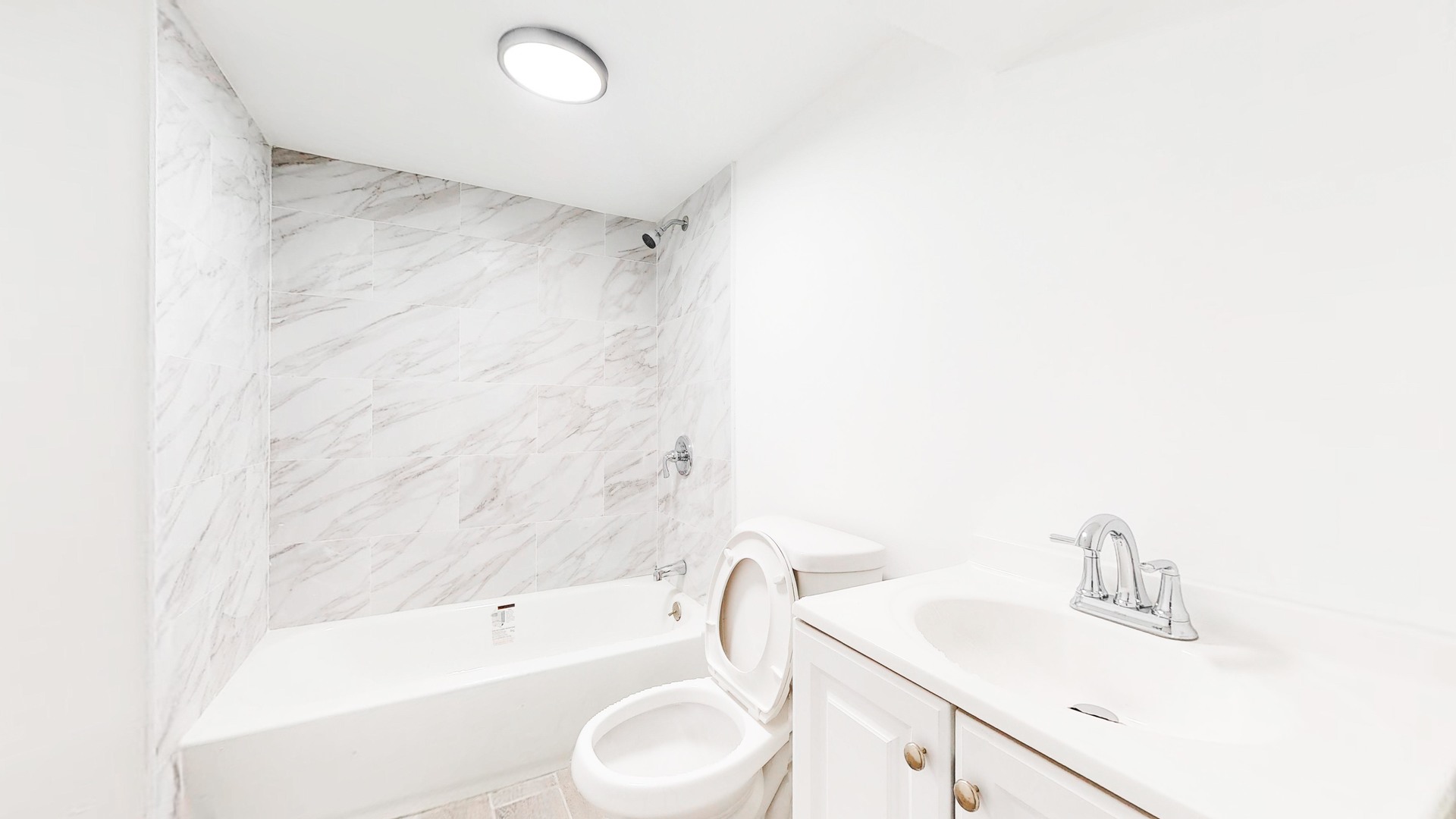 6137 South Morgan Street Chicago, IL 60621 - Photo 28 of 33 a bathroom with a sink a toilet and bathtub