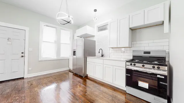 a kitchen with a stove a sink and a refrigerator