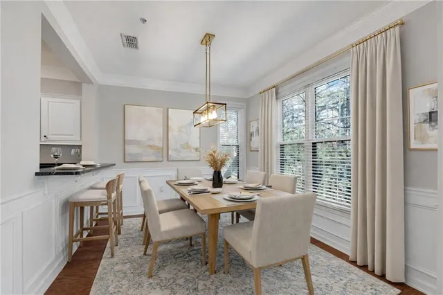 a dining room with furniture a chandelier and wooden floor