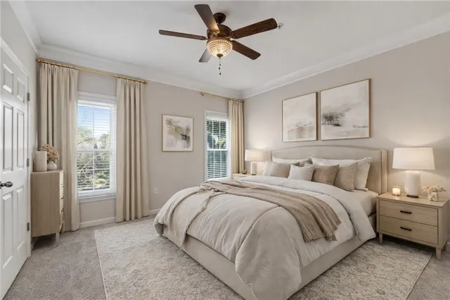 a bedroom with a large bed and a chandelier