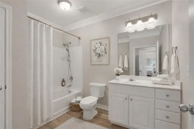 a bathroom with a double vanity sink mirror and toilet