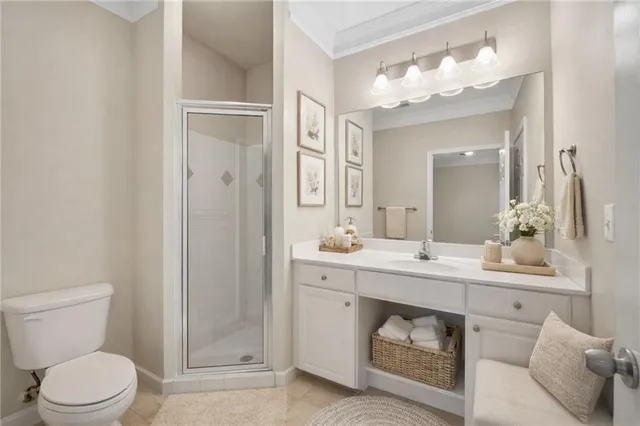 a spacious bathroom with a toilet sink and mirror