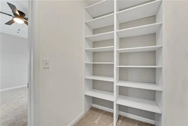 a view of walk in closet with empty racks
