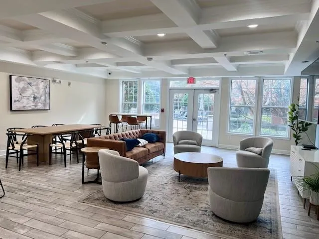a living room with furniture and large windows