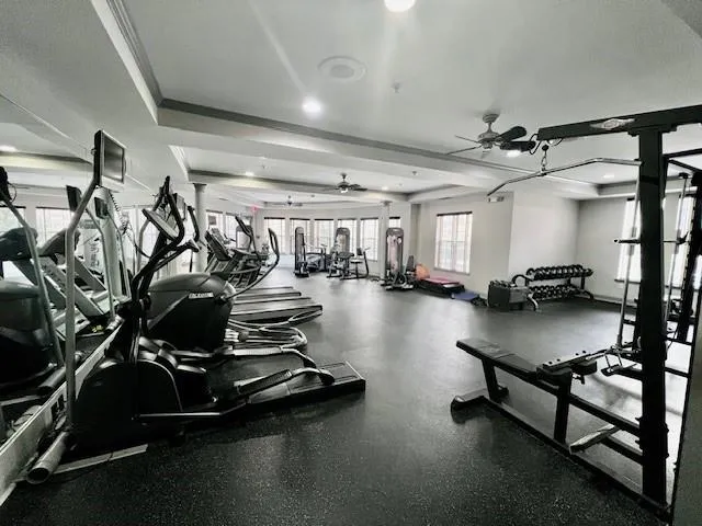 a room with gym equipment and a table
