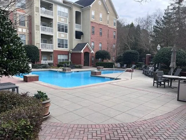 a view of a building with backyard and sitting area