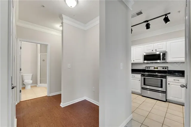 a view of kitchen with sink and electronic appliances