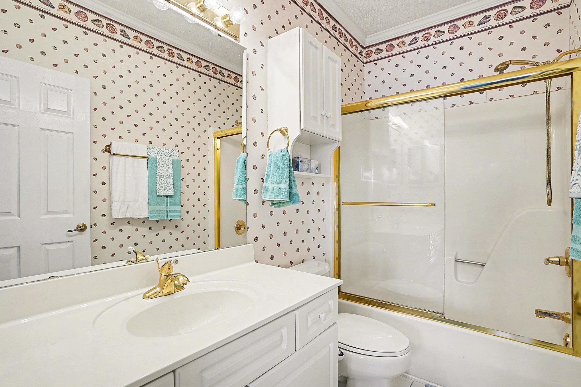 4429 Turtle Lane, Unit 3A Little River, SC 29566 - Photo 19 of 31 Full bathroom with wallpapered walls, vanity, shower / bath combination with glass door, and ornamental molding