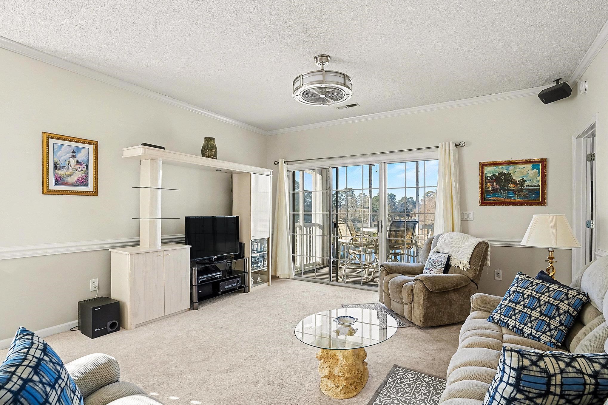 4429 Turtle Lane, Unit 3A Little River, SC 29566 - Photo 5 of 31 Living room featuring carpet floors, ornamental molding, and a textured ceiling