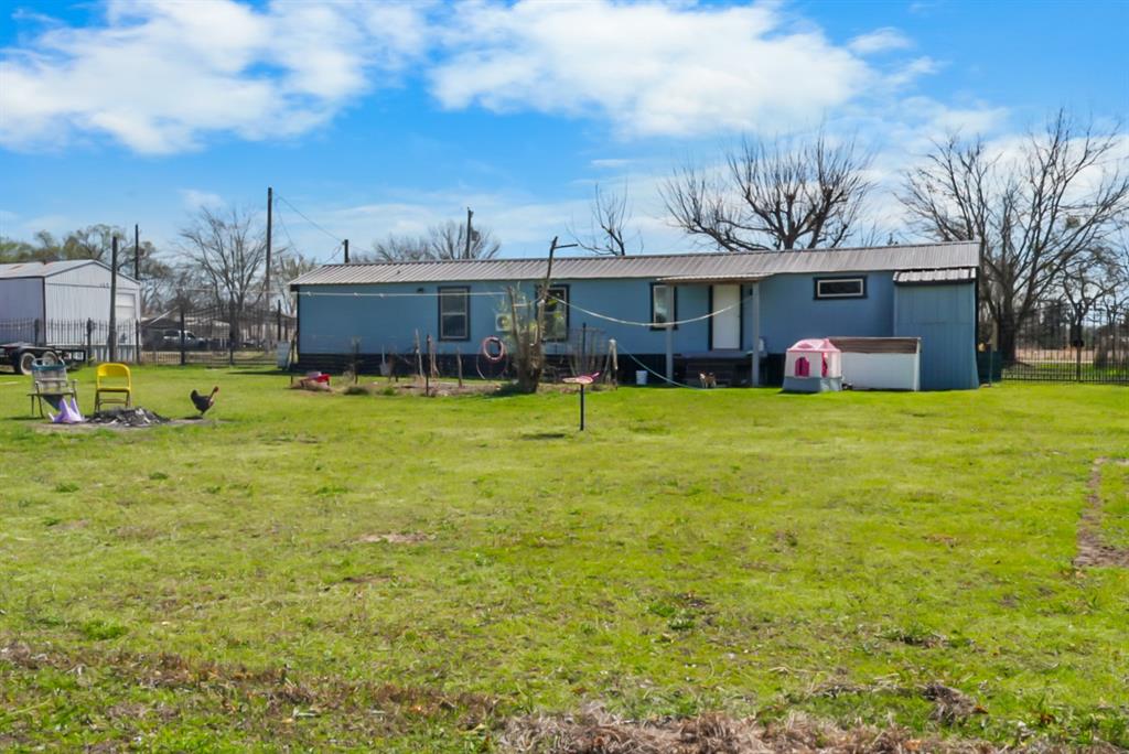 244 Smith Circle Point, TX 75472 - Photo 11 of 15 Back of house with a metal roof