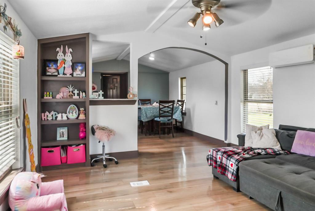 244 Smith Circle Point, TX 75472 - Photo 3 of 15 Living area featuring light wood finished floors, a ceiling fan, and arched walkways