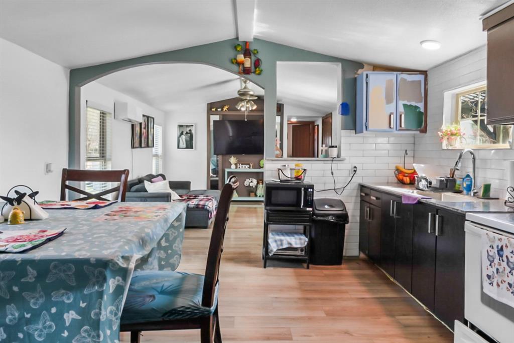 244 Smith Circle Point, TX 75472 - Photo 7 of 15 Kitchen featuring healthy amount of natural light, tasteful backsplash, light wood-style flooring, and arched walkways