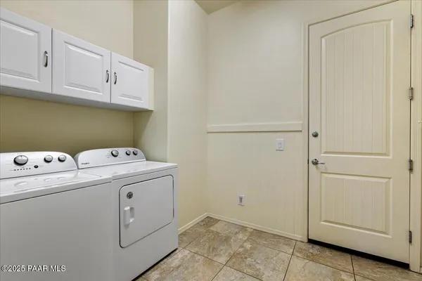 a view of storage and utility room with washer and dryer