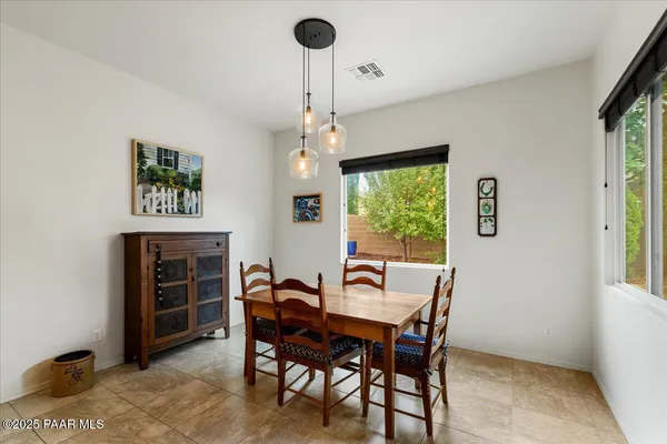 a view of a dining room with furniture window and outside view