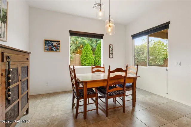 a view of a dining room with furniture and a window
