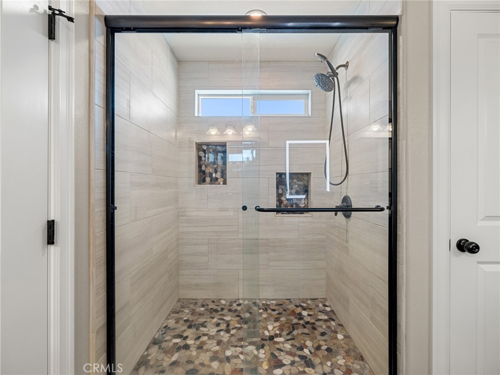 15620 Erie Road Apple Valley, CA 92307 - Photo 27 of 53 a bathroom with a glass shower door