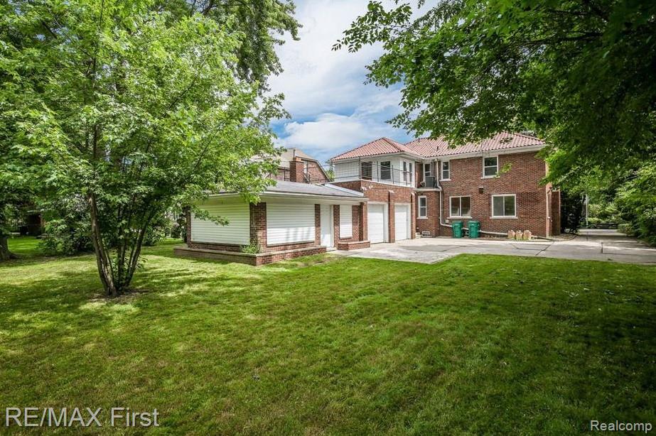 1349 Devonshire Road Grosse Pointe, MI 48230 - Photo 3 of 26 Expansive lawn surrounding a brick residence featuring a red tile roof