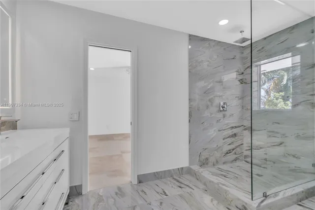 a bathroom with a mirror and a sink