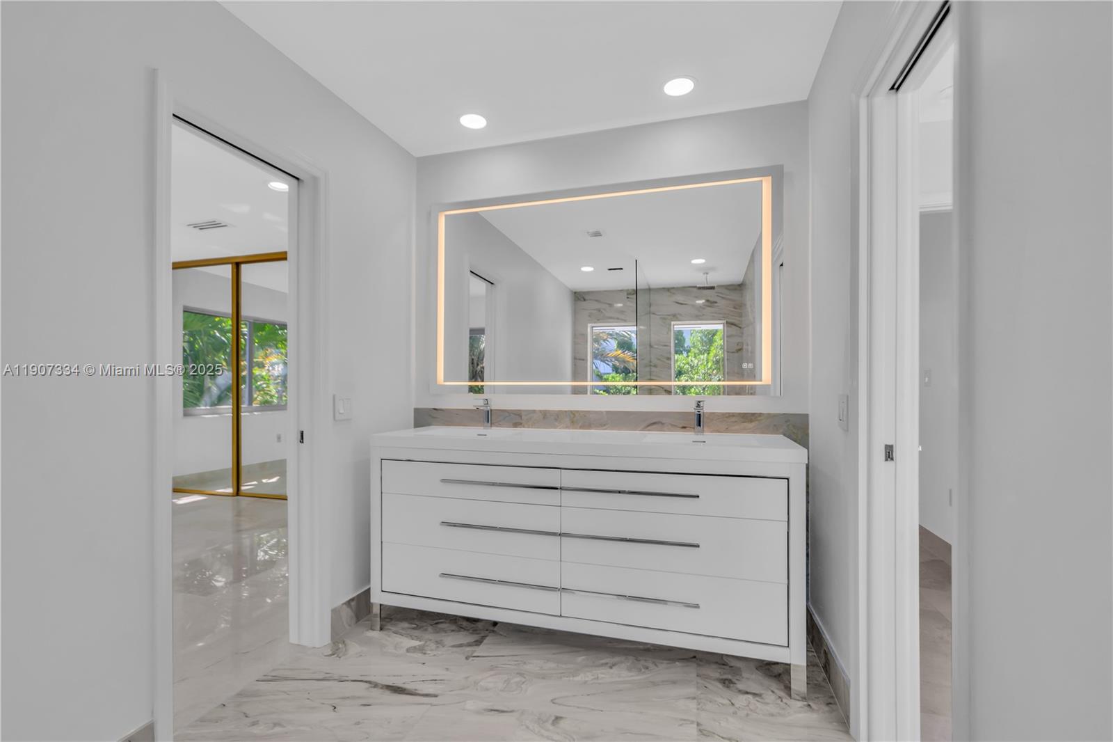 2089 Northeast 121st Road North Miami, FL 33181 - Photo 20 of 30 a bathroom with a mirror and a sink