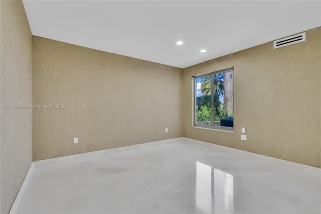 a kitchen with stainless steel appliances granite countertop a stove a refrigerator and a sink with wooden cabinets