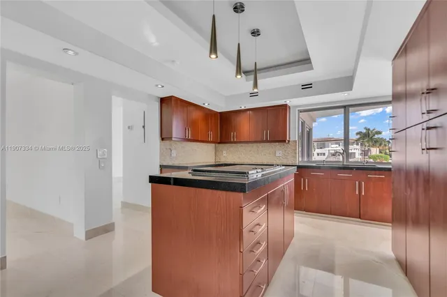 a kitchen with stainless steel appliances granite countertop a sink stove and cabinets