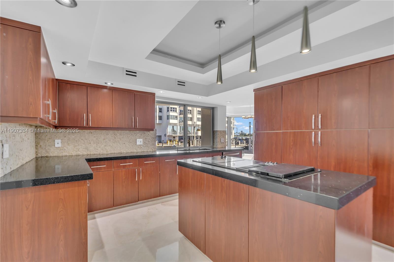 2089 Northeast 121st Road North Miami, FL 33181 - Photo 25 of 30 a kitchen with stainless steel appliances granite countertop a sink stove and cabinets