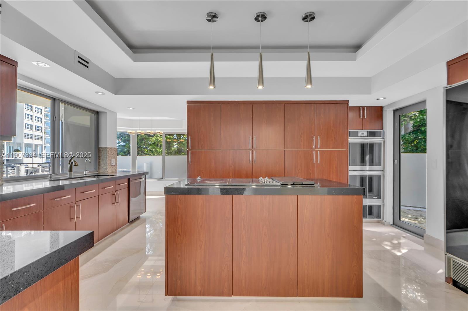 2089 Northeast 121st Road North Miami, FL 33181 - Photo 26 of 30 a kitchen with stainless steel appliances kitchen island granite countertop cabinets and wooden floor