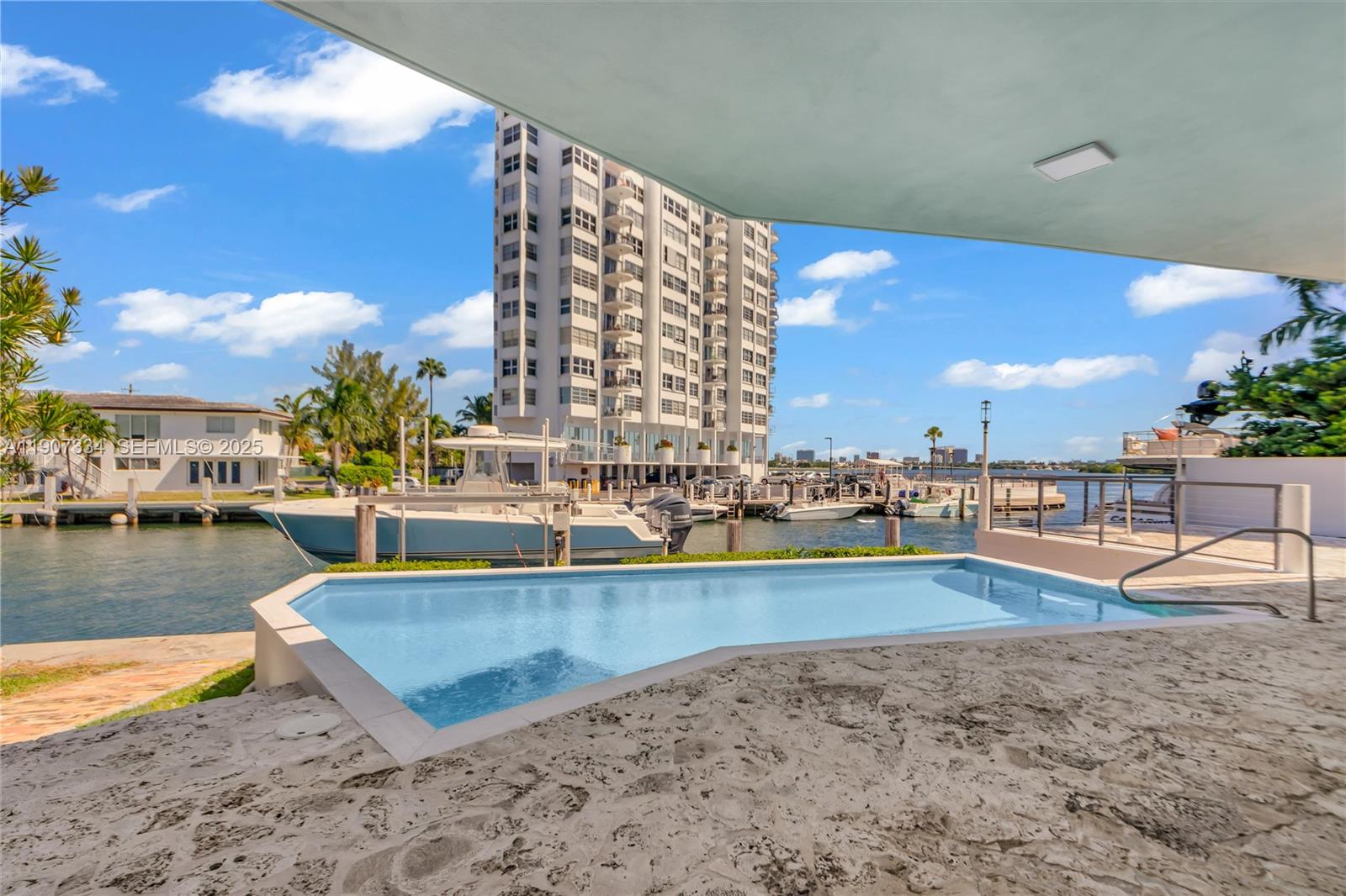 2089 Northeast 121st Road North Miami, FL 33181 - Photo 28 of 30 a view of a swimming pool next to a building