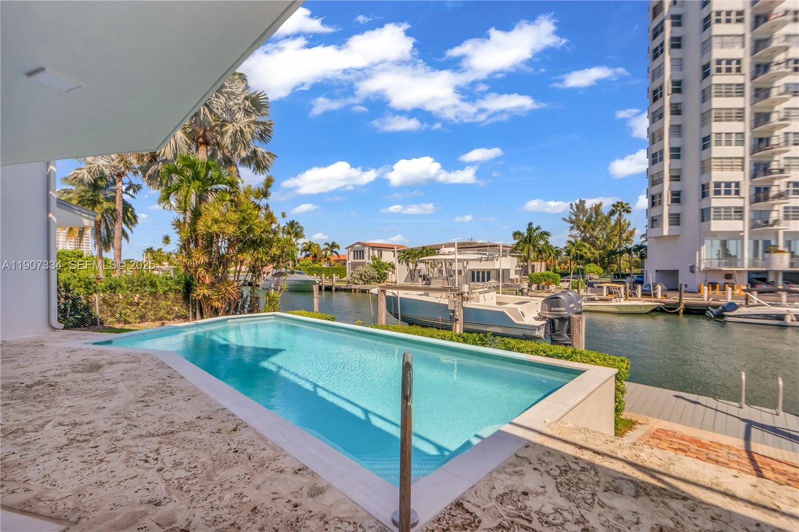 2089 Northeast 121st Road North Miami, FL 33181 - Photo 29 of 30 a view of a swimming pool with a lounge chairs