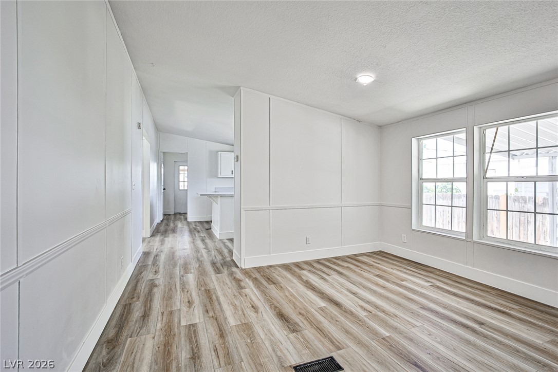 273 Aztec Lane Henderson, NV 89015 - Photo 12 of 28 Step into a refreshed living space with new flooring and bright, naturally illuminated interiors.