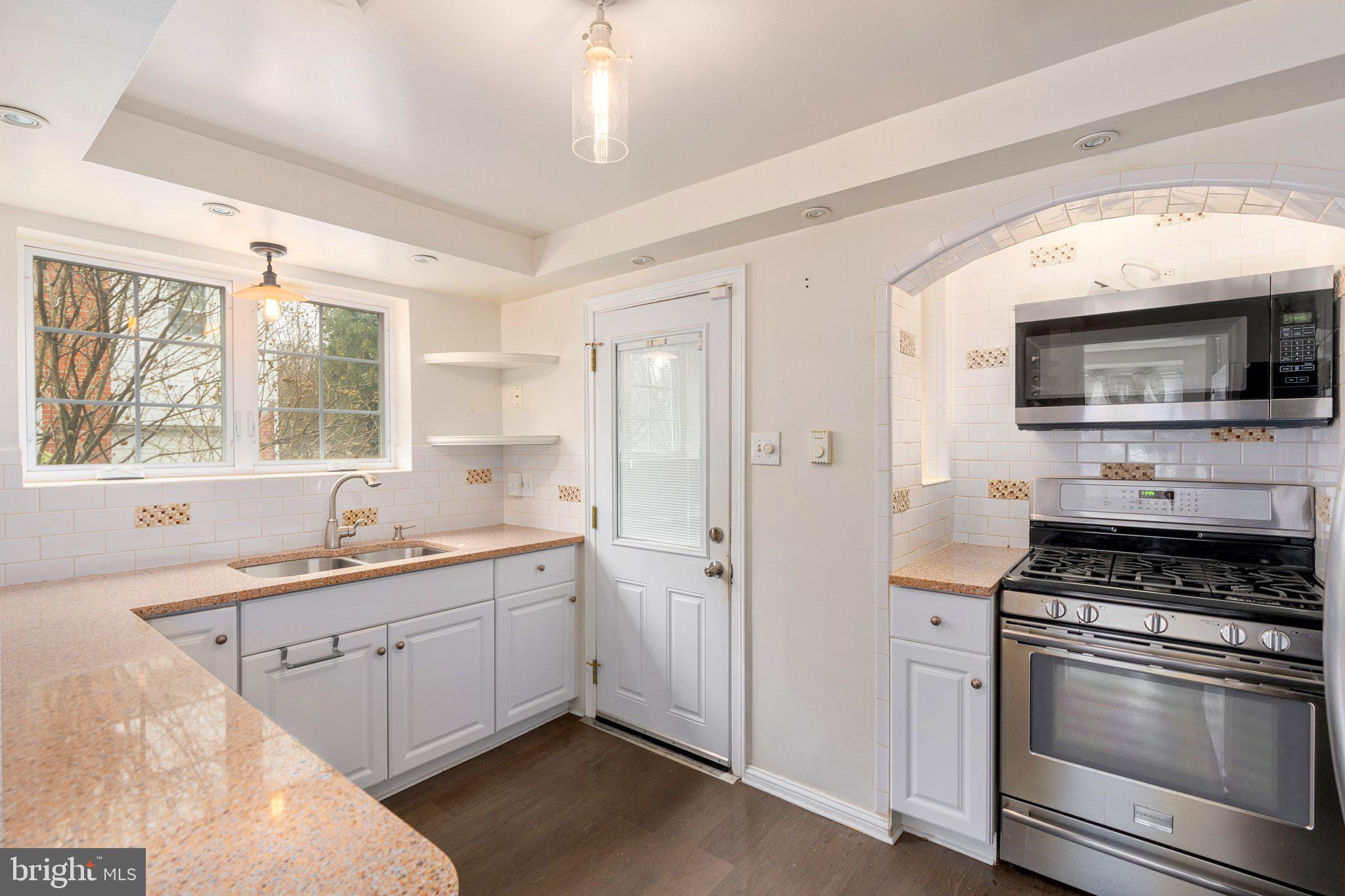 443 Old Farm Road Wyncote, PA 19095 - Photo 16 of 35 a kitchen with stainless steel appliances a sink stove and microwave