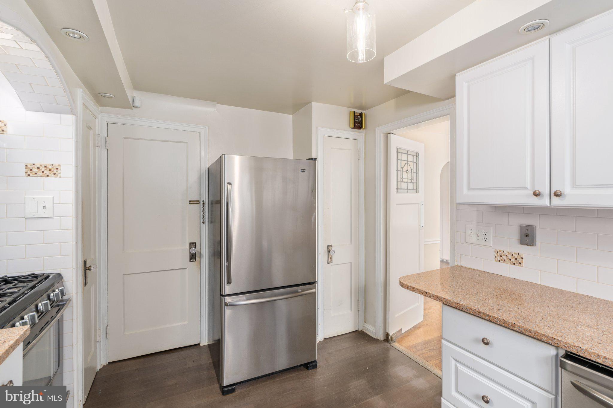 443 Old Farm Road Wyncote, PA 19095 - Photo 18 of 35 a kitchen with stainless steel appliances a refrigerator and cabinets
