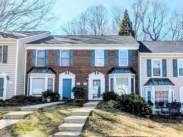 a front view of a house with yard and porch