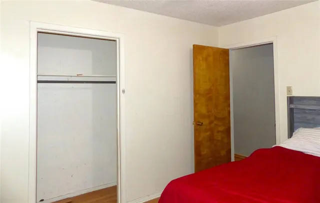 a bedroom with a bed and a closet