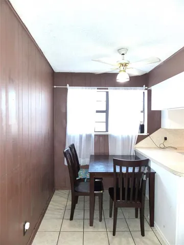 a view of a dining room with furniture and a chandelier