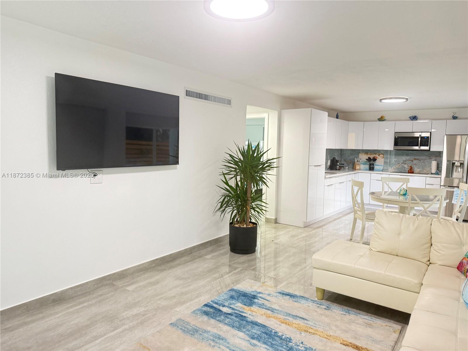 60 Southeast Marlin Avenue, Unit 2 Key Largo, FL 33037 - Photo 1 of 26 a living room with furniture and a flat screen tv