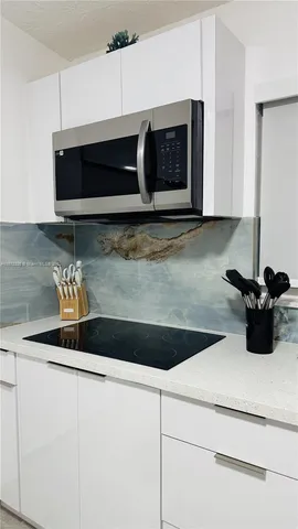 a close view of a microwave stove with kitchen island